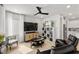 Comfortable living room featuring modern decor, entertainment center, and ceiling fan at 4743 S Sungold St, Pahrump, NV 89061
