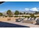 Inviting outdoor lounge area with a firepit, comfortable seating, and breathtaking mountain views at 4743 S Sungold St, Pahrump, NV 89061