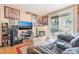 Comfortable living room featuring a fireplace, wood floors, and entertainment center at 4960 Harrison Dr # 131, Las Vegas, NV 89120
