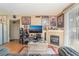 Comfortable living room featuring a fireplace, wood floors, and entertainment center at 4960 Harrison Dr # 131, Las Vegas, NV 89120
