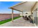 Covered patio area with brick flooring, artificial turf, and outdoor seating at 4977 Vacaville Ave, Las Vegas, NV 89139