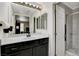 Modern bathroom featuring a vanity with a large mirror and a tiled walk-in shower at 4977 Vacaville Ave, Las Vegas, NV 89139