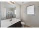 Neutral bathroom featuring a large vanity mirror, single sink, and shower with tub at 4977 Vacaville Ave, Las Vegas, NV 89139