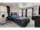 Comfortable bedroom with dark furniture and two windows allowing ample natural light at 4977 Vacaville Ave, Las Vegas, NV 89139