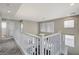 Bright hallway with carpet flooring and white railings overlooking the lower level at 4977 Vacaville Ave, Las Vegas, NV 89139