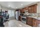 Updated kitchen featuring stainless steel appliances, granite counters, and tile flooring at 4977 Vacaville Ave, Las Vegas, NV 89139