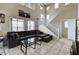 Spacious living room featuring high ceilings, neutral tones, and a comfortable gray sofa at 4977 Vacaville Ave, Las Vegas, NV 89139