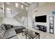 Inviting living room with a comfortable sofa, tile floors, and plenty of natural light at 4977 Vacaville Ave, Las Vegas, NV 89139