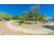 Community walking path featuring mature landscaping and decorative rock for a relaxing outdoor experience at 4977 Vacaville Ave, Las Vegas, NV 89139