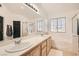 Bright bathroom with double vanity, separate tub, and shower at 525 Sunnys Halo Ct, Henderson, NV 89015