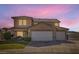 Attractive two-story home featuring a double garage, manicured lawn, and desert landscaping at 525 Sunnys Halo Ct, Henderson, NV 89015