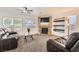 Spacious living room features a fireplace with stone accents, plush furniture, and ample natural light at 525 Sunnys Halo Ct, Henderson, NV 89015