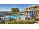 View of a well-maintained backyard with a fenced swimming pool and an open patio seating area at 525 Sunnys Halo Ct, Henderson, NV 89015