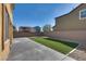 The backyard features turf, rocks, and a concrete patio surrounded by a brick wall at 5269 Ardley Ave, Las Vegas, NV 89141