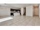 Open-concept living space with tile floors, recessed lighting, and adjacent kitchen area with dark cabinetry at 5269 Ardley Ave, Las Vegas, NV 89141