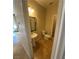 Compact bathroom featuring a pedestal sink, toilet, and neutral wall color at 5361 Candlespice Way, Las Vegas, NV 89135