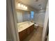 Bright bathroom featuring a double sink vanity and a shower-tub combination at 5361 Candlespice Way, Las Vegas, NV 89135