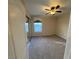 Bedroom with carpeted floor, window with curtain, ceiling fan, and mirrored closet at 5361 Candlespice Way, Las Vegas, NV 89135