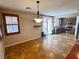 Dining area adjacent to the kitchen and patio doors, features tile floors and modern light fixture at 5361 Candlespice Way, Las Vegas, NV 89135