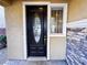Elegant front door with decorative glass, enhanced by natural light and stylish stone detailing at 5361 Candlespice Way, Las Vegas, NV 89135