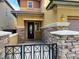 Close up of the front entrance featuring stone accents and a secure wrought-iron gate for added curb appeal at 5361 Candlespice Way, Las Vegas, NV 89135