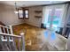 Bright living room featuring wood shutter windows, floating shelves, and glass doors to the backyard at 5361 Candlespice Way, Las Vegas, NV 89135