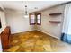 Cozy living space with wood shutter windows, floating shelves, and travertine tile flooring at 5361 Candlespice Way, Las Vegas, NV 89135