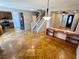 Inviting open-concept living area with travertine tile flooring, staircase, and updated lighting fixtures at 5361 Candlespice Way, Las Vegas, NV 89135