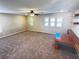 Large living room featuring neutral carpet, multiple windows with shutters, built-in shelving and attached table at 5361 Candlespice Way, Las Vegas, NV 89135