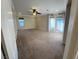 Large living room featuring neutral carpet, French doors, ceiling fan, and large window at 5361 Candlespice Way, Las Vegas, NV 89135