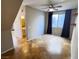 Bright living area with tile floors, ceiling fan, window with curtains, and floating shelves at 5361 Candlespice Way, Las Vegas, NV 89135