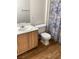 Bathroom features vanity with white countertop, toilet, and a shower with a blue patterned curtain at 5710 E Tropicana Ave # 2003, Las Vegas, NV 89122