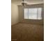 Spacious bedroom featuring a ceiling fan and natural light from a large window at 5710 E Tropicana Ave # 2003, Las Vegas, NV 89122