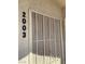 Security screen on building exterior with unit number at 5710 E Tropicana Ave # 2003, Las Vegas, NV 89122