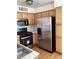 Kitchen features stainless steel appliances, wood cabinets, and hard wood floors at 5710 E Tropicana Ave # 2003, Las Vegas, NV 89122