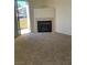 Spacious living room with a fireplace and sliding glass door to an outdoor patio at 5710 E Tropicana Ave # 2003, Las Vegas, NV 89122