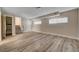 Spacious basement area with wood-look flooring and staircase visible, illuminated by natural light at 6121 Edgewood Cir, Las Vegas, NV 89107