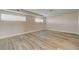 Basement featuring wood-look flooring, neutral walls, and two windows for natural light at 6121 Edgewood Cir, Las Vegas, NV 89107