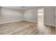 Bright room featuring wood-look flooring and neutral walls, with doorway to adjoining room at 6121 Edgewood Cir, Las Vegas, NV 89107