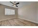 Inviting bedroom with wood-look floors, neutral walls, and a modern ceiling fan at 6121 Edgewood Cir, Las Vegas, NV 89107