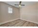 Bright bedroom features wood-look flooring, ceiling fan, and ample natural light from the window at 6121 Edgewood Cir, Las Vegas, NV 89107