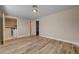 Bedroom features wood-look flooring, neutral walls, and a view into laundry area at 6121 Edgewood Cir, Las Vegas, NV 89107