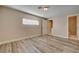 Bedroom features wood-look flooring, neutral walls, and a view into a bathroom at 6121 Edgewood Cir, Las Vegas, NV 89107
