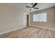 Bedroom with wood-look flooring, closet with sliding doors and large window at 6121 Edgewood Cir, Las Vegas, NV 89107