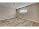 Bright room featuring wood-look flooring and neutral walls, illuminated by natural light at 6121 Edgewood Cir, Las Vegas, NV 89107