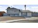 Exterior shot of a two-story home with a garage, and simple landscaping at 6121 Edgewood Cir, Las Vegas, NV 89107
