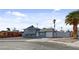 Shot of a two-story home with a garage, and minimal landscaping at 6121 Edgewood Cir, Las Vegas, NV 89107