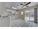 An airy kitchen features bright cabinets and a sliding door to the pool at 6121 Edgewood Cir, Las Vegas, NV 89107