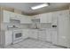 Charming kitchen with white cabinets, appliances, and plenty of natural light at 6121 Edgewood Cir, Las Vegas, NV 89107
