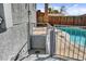 Side yard showcasing a fenced pool, stucco exterior and convenient backyard access at 6121 Edgewood Cir, Las Vegas, NV 89107